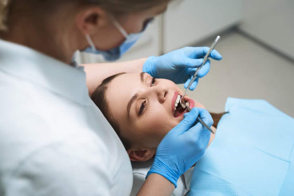 Patient receiving a dental implant consultation for permanent tooth replacement and improved oral health.