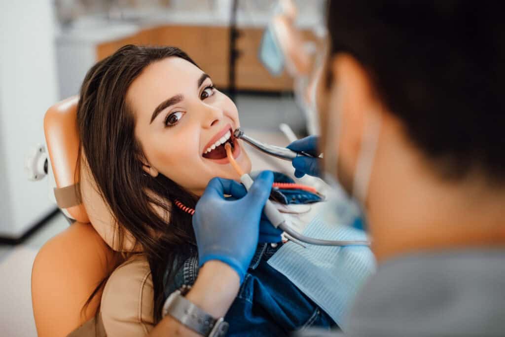 Patient receiving a dental implant consultation and oral examination at a modern dental clinic in Reading, MA.
