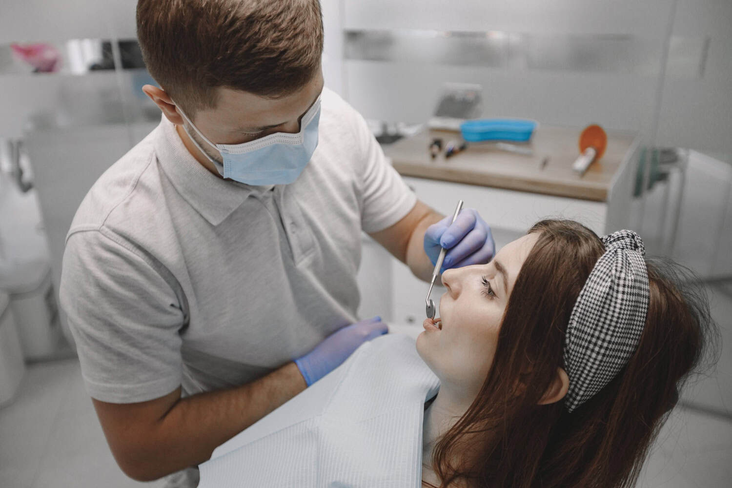 Dentist performing a root canal treatment during a dental examination to help save a natural tooth.