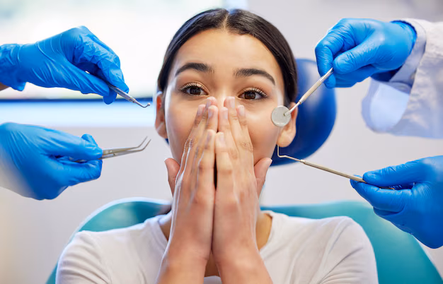 Dental patient experiencing anxiety during a dental examination with dental instruments nearby